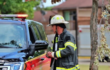 Chief Cunningham is speaking to the Incident Commander at a house fire.
